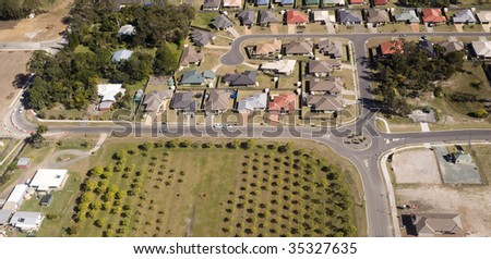 Aerial view of a housing estate in Queensland showing colorful roof tops