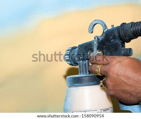 Hand with spray paint gun