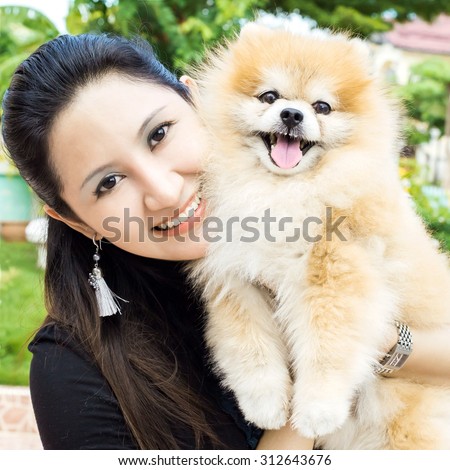 Happy woman and dog in her house
