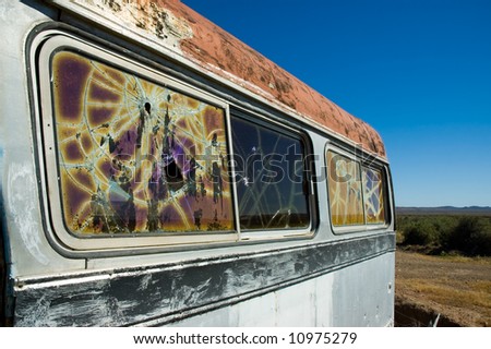 abandoned bus in the patagonian steppe with broken windows.