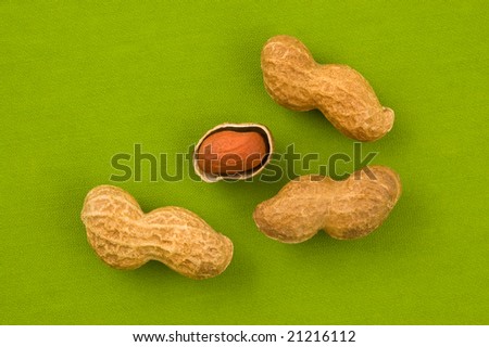 Peanuts on green background, close up shot.