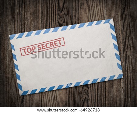 Open  envelope with top secret stamp, on wooden table, clipping path.