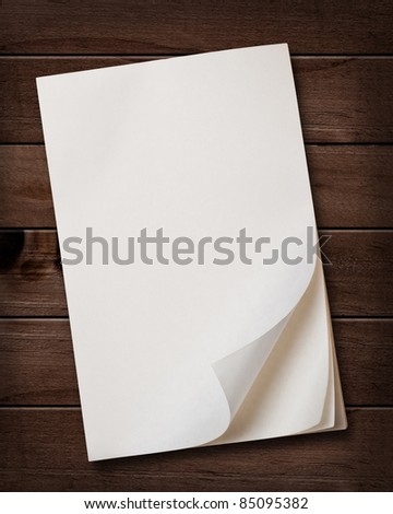 Old note paper block on wood background.