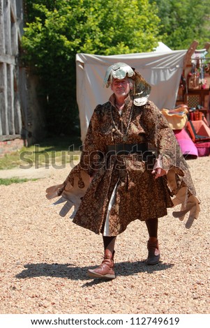 ARVILLE,FRANCE, MAY 23:A medieval character walking during a show on May 23 2010 in Arville,France.There was a medieval market in the gardens of a well preserved Templars Commanderie in France.