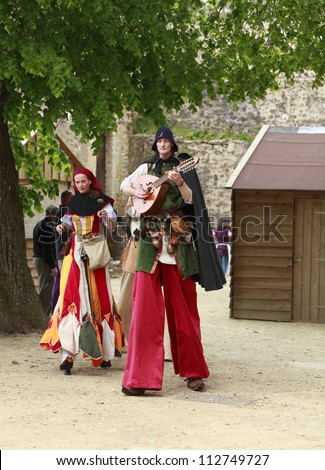 NOGENT LE ROTROU,FRANCE,MAY15 :Medieval troubadours on stilts walking and singing during a historical reenactment festival near Saint Jean Castle on May 15 2010 in Nogent le Rotrou,France