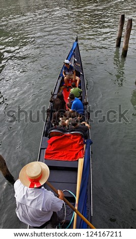 VENICE-JULY 28:Unidentified tourists in a gondola on the Grand Canal in Venice on July 28, 2011.There were several thousand gondolas in the 18th century, with only several hundred today for tourism.