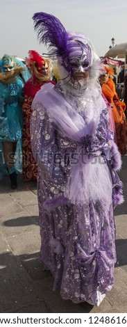 VENICE-FEB 18: Unidentified person wearing a purple Venetian disguise on February 18, 2012 in Venice. In 2012 the Venice Carnival was held between 11- 21 February.