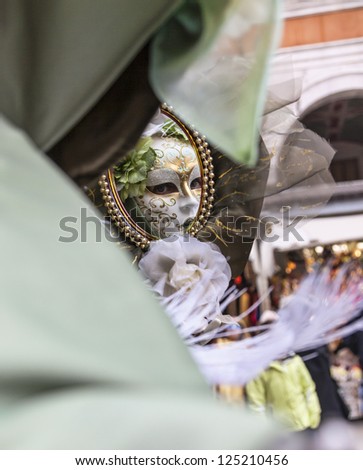 VENICE-FEB 19: Image of the reflection in a mirror of an unidentified person in a specific Venetian mask on February 19, 2012 in Venice. In 2012 the Venice Carnival was held between 11- 21 February.