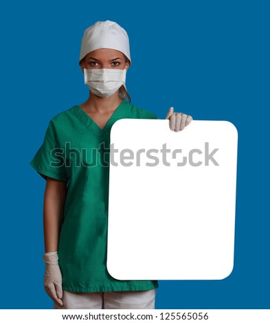 A young woman doctor holding an empty white bill board against a blue background.
