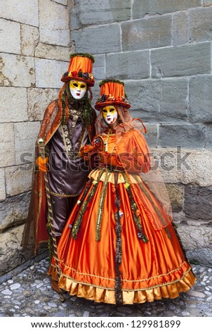 ANNECY, FRANCE, FEB 23:Unidentified couple disguised in orange costumes in Annecy, France,on February 23, 2013.Every year in Annecy is held a Venetian Carnival to celebrate the beauty of real Venice.
