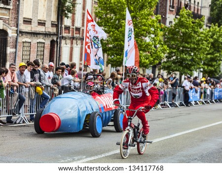 SAINT QUENTIN,FRANCE, JUL 5:Funny character riding a bicycle, during the passing of publicity caravan in the stage 5 of Le Tour de France on July 5 2012 in Saint Quentin  .