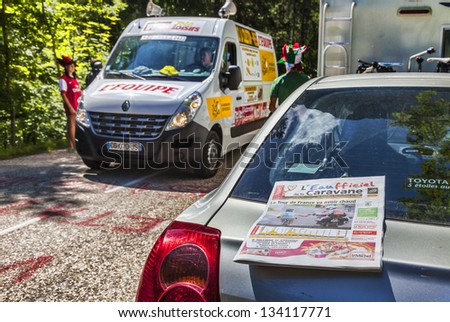 LA PALUD,FRANCE,JUL 13:The daily newspaper is on a car on the road to Col du Granier during the passing of the Publicity Caravan in the 12 stage of the Le Tour de France on July 13 2012 in La Palud.