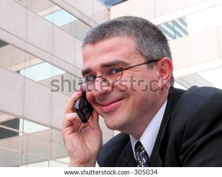 businessman with phone smiling