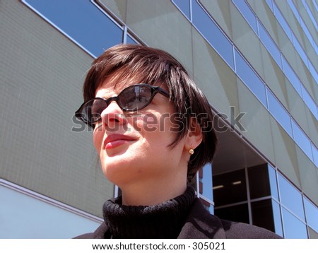 Businesswoman looking away near an office building-natural lighting