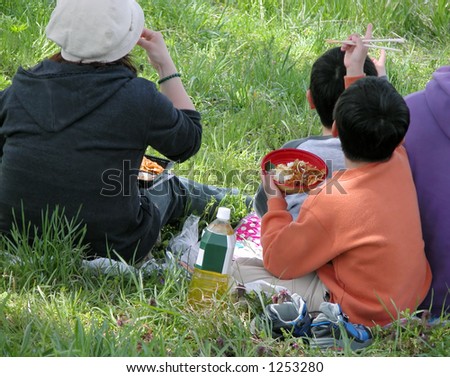 A Japanese family eating outdoor during early spring season-