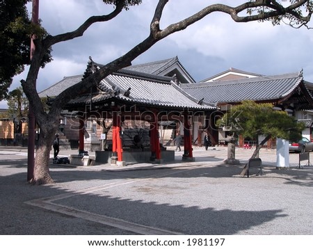 Traditional Buddhist architecture in the yard of a temple from Kyoto. Natural lights and shadows during a cloudy summer day.