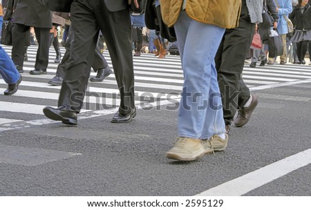 Low angle image of a people crowd crossing the street