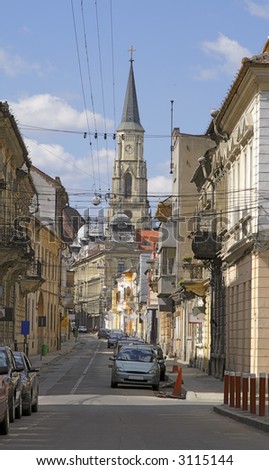 Interesting image of the St.Michael cathedral and a traditional colateral street- Cluj Napoca, Romania.