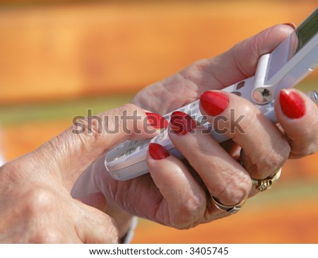 Close-up image of the senior woman hands using a mobile phone.