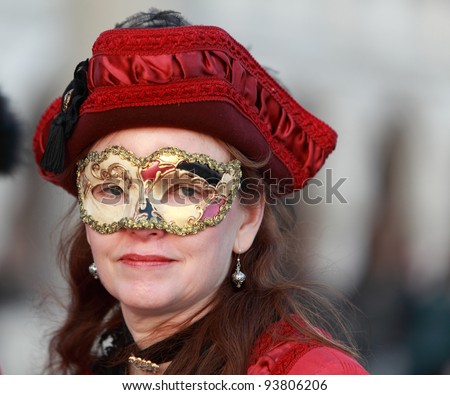 VENICE, ITALY - FEBRUARY 26: Unidentified woman in Venetian mask at St. Mark\'s Square participates in the Carnival of Venice on February 26, 2011 in Venice, Italy. In 2012 the Carnival will be between 11- 21 February.