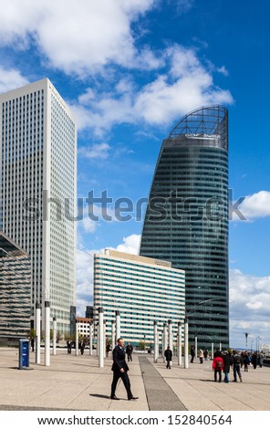 PARIS,APRIL 19:Unidentified businesspeople walking in the major business district, La Defense,in western of Paris,France on April 19 2012. Here are many of the Paris urban area\'s tallest high-rises