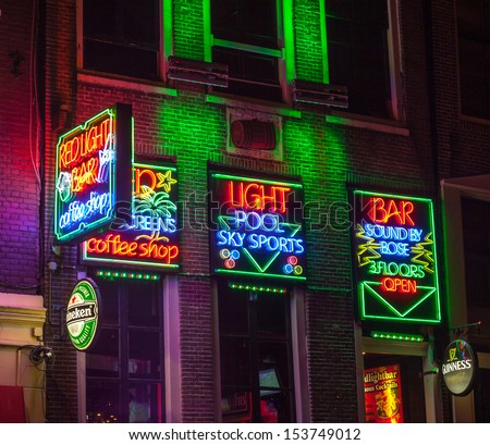 AMSTERDAM - OCT 31: Night image of colorful coffee shop signs in the red district on October 31, 2011, in Amsterdam, the Netherlands. It is probably the most famous tourist site in town.