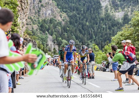 ALPE D\'HUEZ, FRANCE, JUL 18:Three cyclists climbing the difficult road to Alpe-D\'Huez, during the stage 18 of the edition 100 of Le Tour de France  on July 18 2013