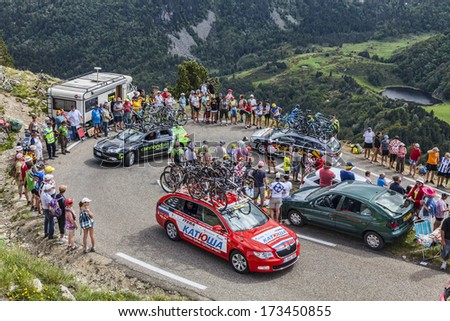 PORT DE PAILLERES,FRANCE- JUL 6:Row of technical cars of various procycling teams climbing the road to Col de Pailheres in Pyrenees Mountains during the stage 8 of Le Tour de France on July 6, 2013.