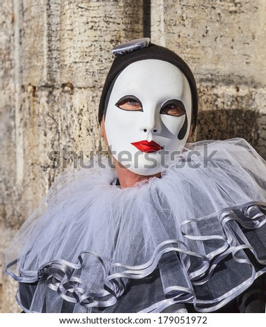 VENICE-FEB 18:Portrait of a person in a white mask with a black teardrop posing near the Doge\'s Palace on February 18, 2012 in Venice.In 2014 the Venice Carnival is between February 15- March 4