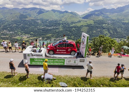 VAL LOURON,FRANCE - JUL 7:Truck transporting a Skoda car during the passing of the advertising caravan on  the road to Col de Val Louron Azet in the stage 9 of Le Tour de France on July 7 2013