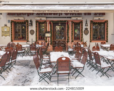 MUNICH,GERMANY- DEC 19: Image of a terrace covered by snow in front of the entrance in a traditional Bavarian Restaurant in Munich,Germany on 19 December 2014.