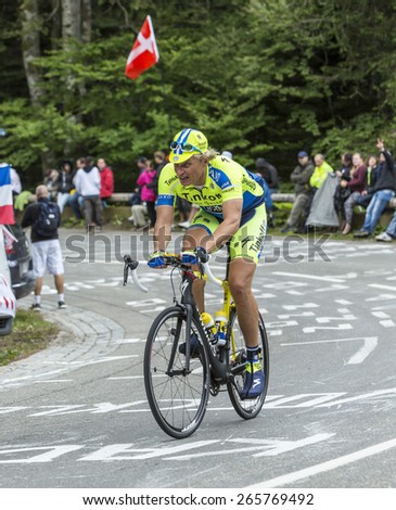 LE MARKSTEIN, FRANCE - JUL 13:Oleg Thinkov,the owner of Team Saxo Bank Thinkoff, riding a bicycle on Le Markstein before the apparition of the peloton in the stage 9 of Le Tour de France 2014.
