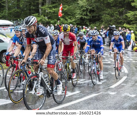 LE MARKSTEIN, FRANCE - JUL 13:The peloton,including Heinrich Haussler  of IAM Cycling Team, climbs the road to mountain pass Le Markstein in Vosges Mountains,during Le Tour de France on July 13, 2014.
