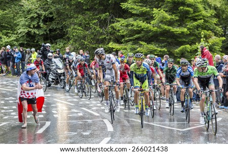 LE MARKSTEIN, FRANCE - JUL 13:The peloton riding on the road to mountain pass Le Markstein during Le Tour de France on July 13, 2014