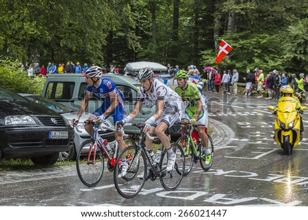 LE MARKSTEIN, FRANCE - JUL 13:Three cyclists, Jean-Marc Bideau, Mathieu Ladagnous, Kristijan Koren, climbing the road to mountain pass Le Markstein during Le Tour de France on July 13, 2014