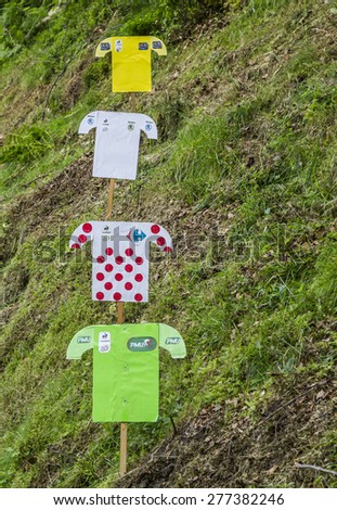 BAGNERES-DE-BIGORRE,FRANCE-JUL 24:Paper decoration of distinctive jerseys of Le Tour de France are on a green slope on the roadside to Col de Tourmalet during the stage 18 of Le Tour de France 2014.