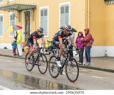 GERARDMER,FRANCE - JUL 12:Two cyclists,Jerome Pineau and Marcel Wyss (IAM Cycling Team) ride during a rainy day the stage 8 of Le Tour de France on July 12, 2014 in Gerardmer