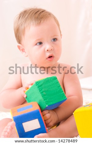 Cute little boy with soft cubes toy