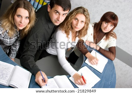Group of business people writing notes