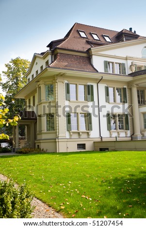 Beautiful european house with green lawn