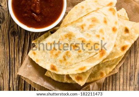 Homemade flatbread with meat, cheese, and salsa viewed from above. Yantyk - traditional Crimean tatar flat bread