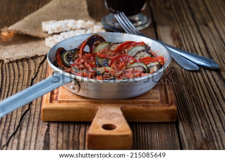 Ratatouille, stewed vegetable dish with tomatoes, zucchini in frying pan