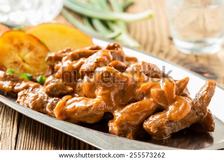 Beef Stroganoff,  original recipe of russian dish. Thin strips of beef  cooked in sour cream and tomato paste,  served with crisp potato