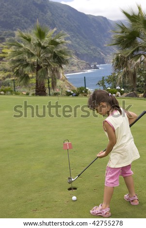 Elementary age girl practicing golf swing