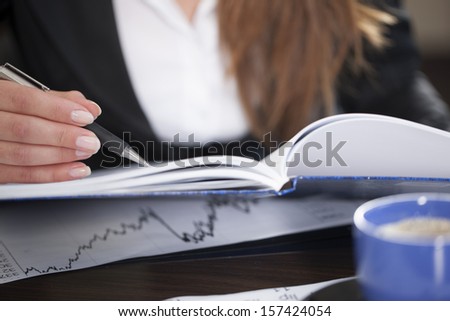 Businesswoman writing notes, space for copy. Selective focus