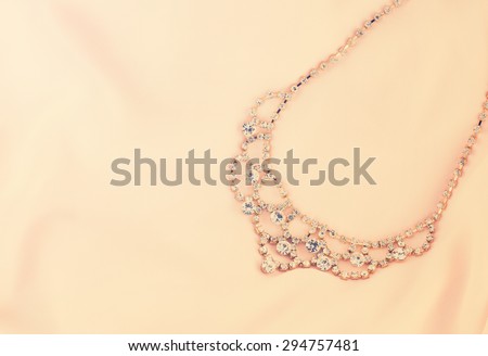 Beautiful gold and diamond necklace on pink background