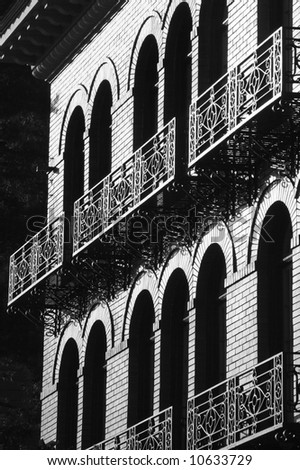 Black and white of arch windows and metal railings