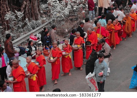 Wat Phra That Doi Tung Chiangrai, Thailand - March 15: someday early in the morning, the monks walk the streets to beg give food offerings to a Buddhist monk on March 15, 2014 inChiangrai, Thailand