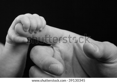 Baby Hand Reaches for Adult Hand