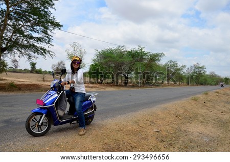 Traveler thai woman ride motorcycle travel around Ancient City in Bagan (Pagan) Archaeological Zone, Myanmar with over 2000 Pagodas and Temples.